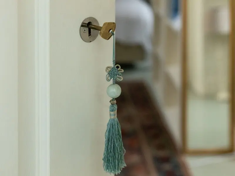 house key with blue tassel