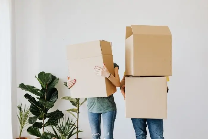 two people moving boxes