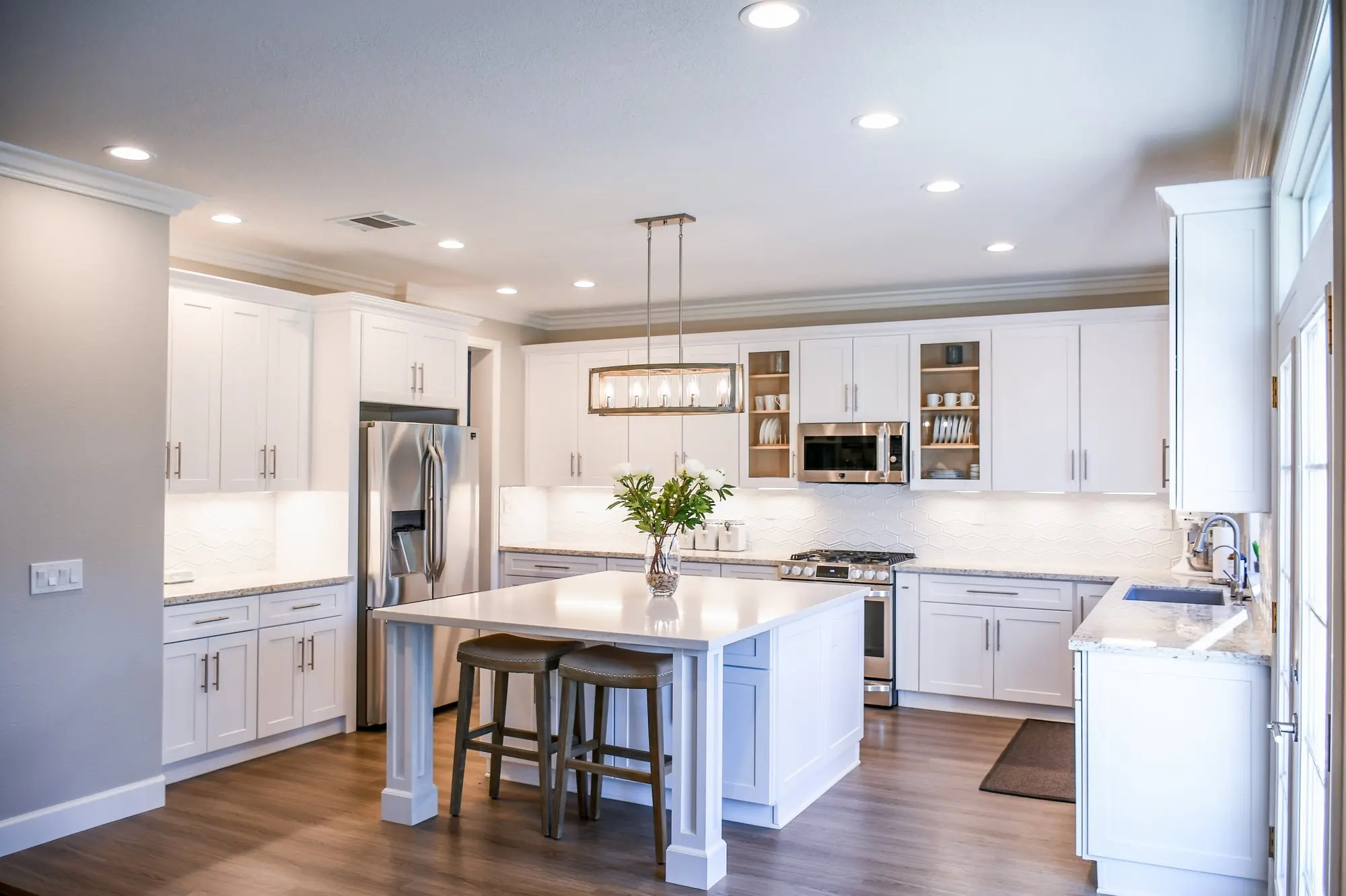 Kitchen painted white with stainless steel appliances | Spyglass Realty